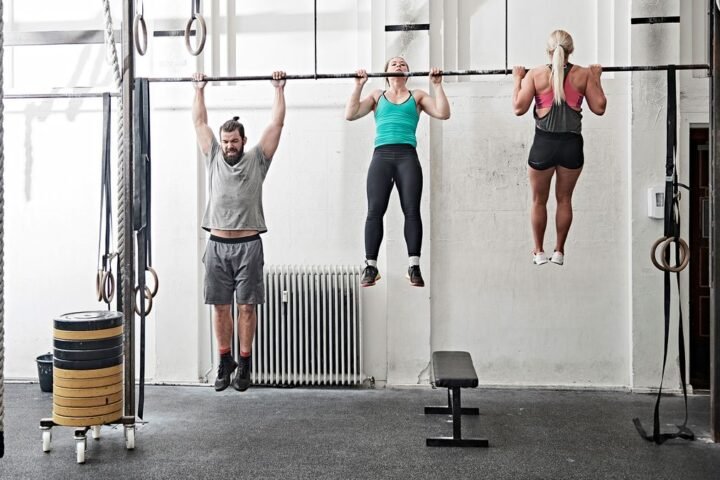 Three people doing pull-ups