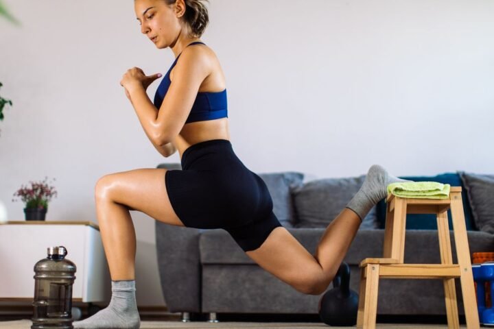 Woman performing high knee hold