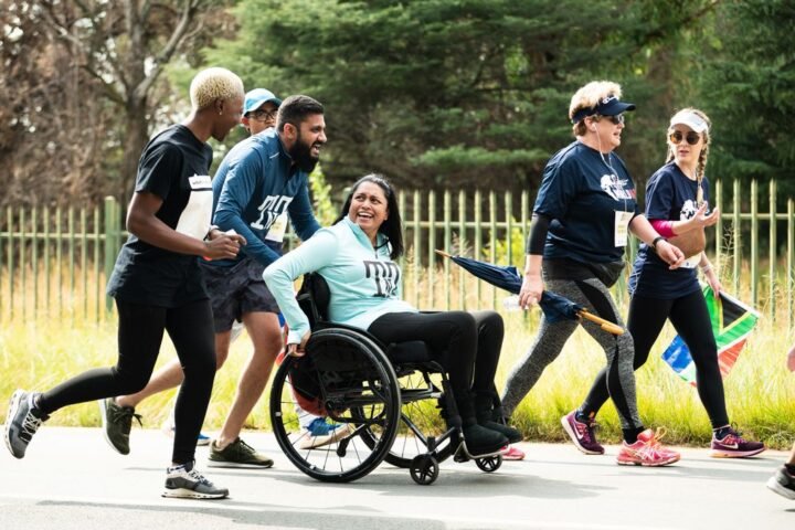 Runners and a wheelchair user take part in the Wings for Life World Run App Run in Johannesburg, South Africa, on May 7, 2023.
