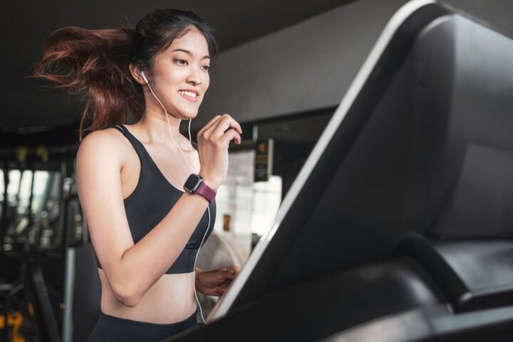 Woman running on treadmill in gym