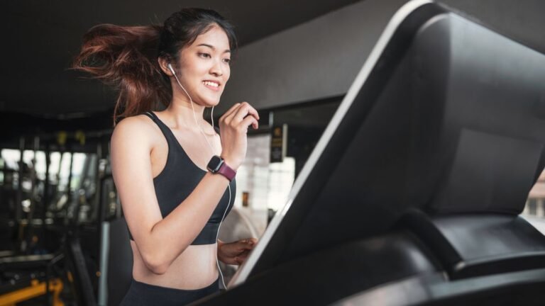 Woman running on treadmill in gym