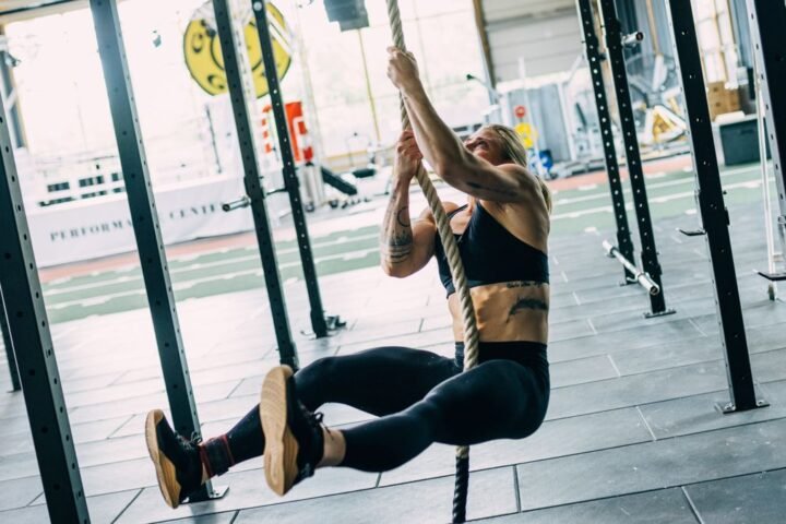 CrossFit athlete Emma Tall performing a hands-only rope climb